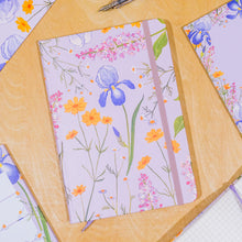Load image into Gallery viewer, Floral notebook with a pen on a wooden surface
